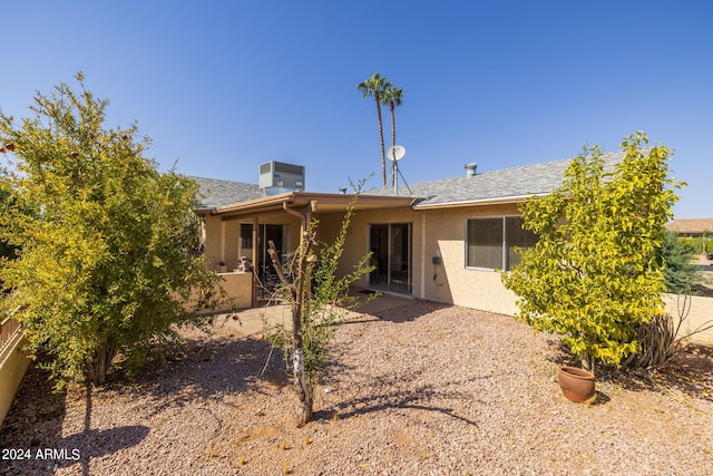rear view of house featuring stucco siding and a patio