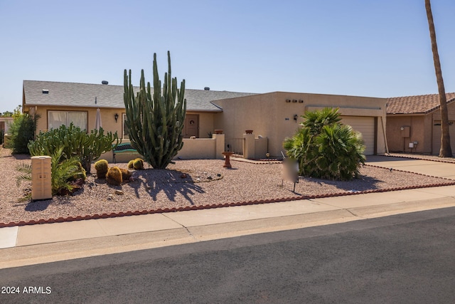 view of front of property with stucco siding, an attached garage, and concrete driveway