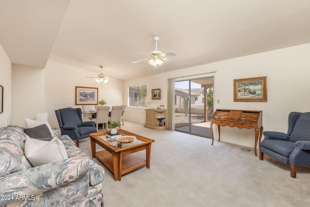 living room with vaulted ceiling, ceiling fan, and light carpet