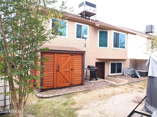 rear view of house with central AC