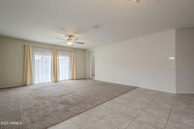 spare room with light carpet and ceiling fan