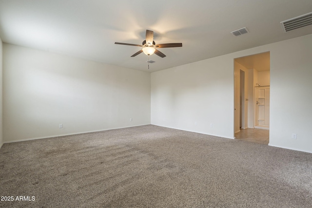 unfurnished room with ceiling fan and carpet