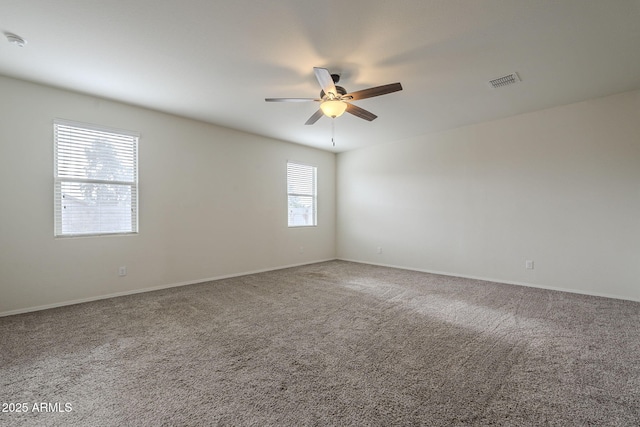 spare room featuring ceiling fan and carpet