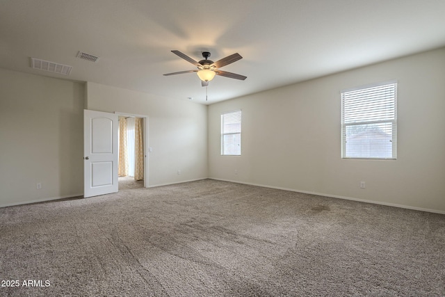 unfurnished room featuring ceiling fan and carpet flooring