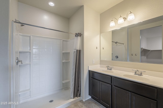 bathroom with tile patterned floors, a shower with shower curtain, and vanity