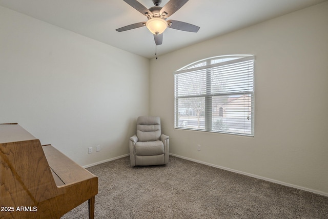 living area with ceiling fan and carpet flooring