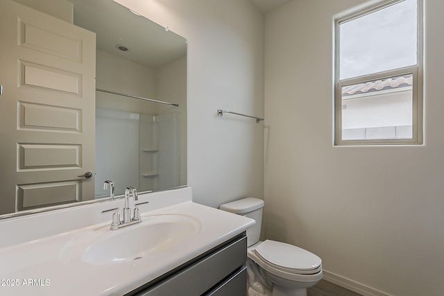 40030 W Bunker Dr, Maricopa, AZ 85138 - full bathroom featuring baseboards, toilet, a shower, vanity, and wood finished floors