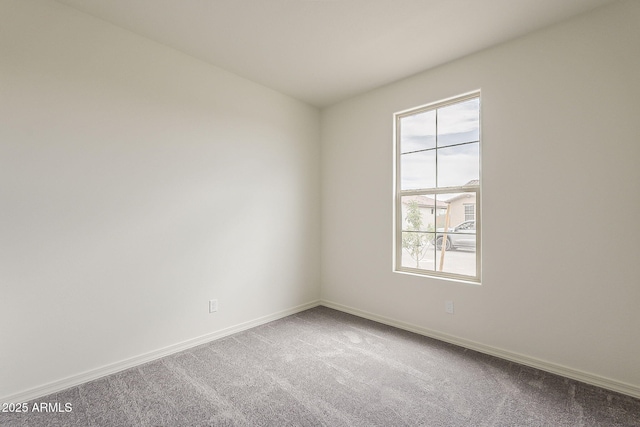 40030 W Bunker Dr, Maricopa, AZ 85138 - spare room featuring carpet flooring and baseboards