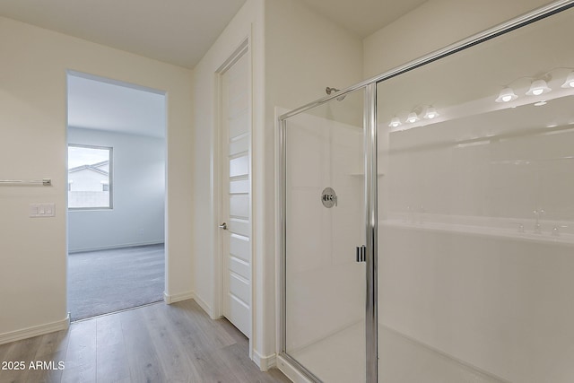 40030 W Bunker Dr, Maricopa, AZ 85138 - bathroom featuring baseboards, a stall shower, and wood finished floors