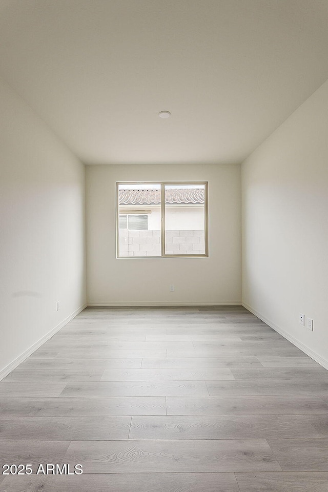 40030 W Bunker Dr, Maricopa, AZ 85138 - spare room featuring light wood-style floors and baseboards