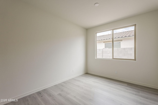 40030 W Bunker Dr, Maricopa, AZ 85138 - empty room with light wood-style flooring and baseboards