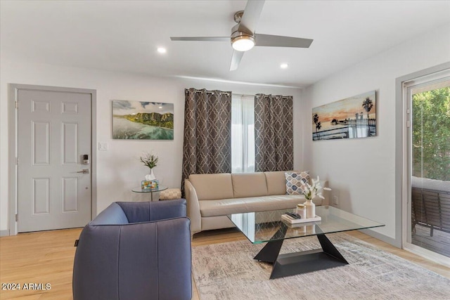 living room with wood-type flooring and ceiling fan