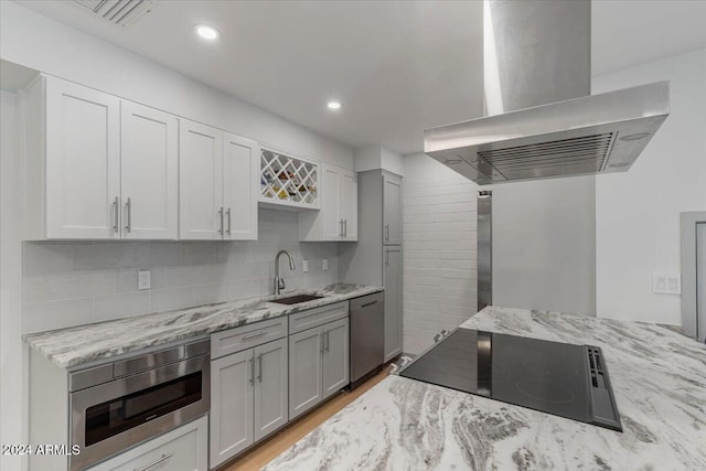 kitchen with built in microwave, dishwasher, sink, range hood, and black electric cooktop