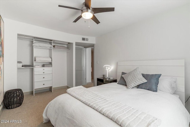 bedroom featuring light carpet, a closet, and ceiling fan