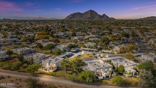 aerial view at dusk featuring a mountain view