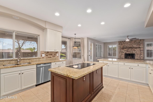 1211 E Desert Flower Ln, Phoenix, AZ 85048 - kitchen with dishwasher, black electric cooktop, a kitchen island, a ceiling fan, and a fireplace
