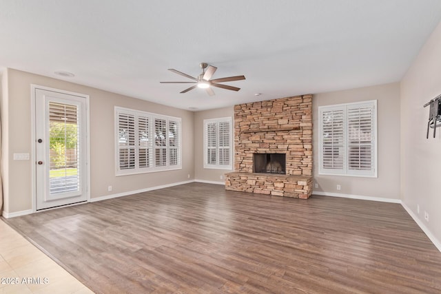 1211 E Desert Flower Ln, Phoenix, AZ 85048 - unfurnished living room with a ceiling fan, wood finished floors, and a fireplace