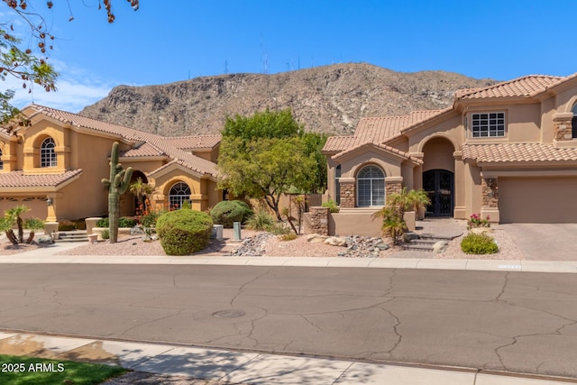 1211 E Desert Flower Ln, Phoenix, AZ 85048 - mediterranean / spanish-style house with stucco siding, a mountain view, driveway, and a tile roof