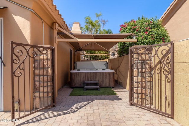 1211 E Desert Flower Ln, Phoenix, AZ 85048 - view of patio featuring a hot tub and a gate