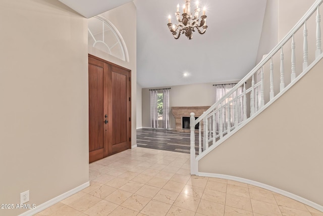 1211 E Desert Flower Ln, Phoenix, AZ 85048 - entryway with stairway, a chandelier, a fireplace, and high vaulted ceiling