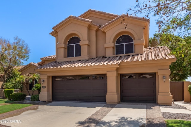 1211 E Desert Flower Ln, Phoenix, AZ 85048 - mediterranean / spanish-style home with driveway, an attached garage, a tile roof, and stucco siding