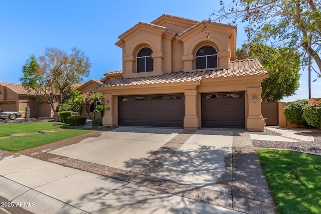 1211 E Desert Flower Ln, Phoenix, AZ 85048 - mediterranean / spanish-style home with stucco siding, a tiled roof, concrete driveway, and an attached garage