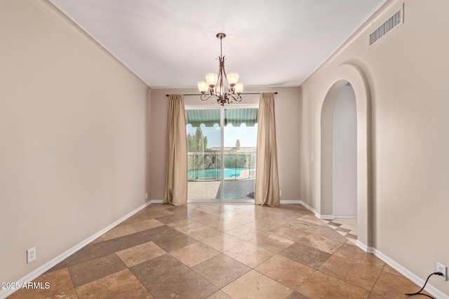1211 E Desert Flower Ln, Phoenix, AZ 85048 - spare room with stone tile floors, a chandelier, and arched walkways