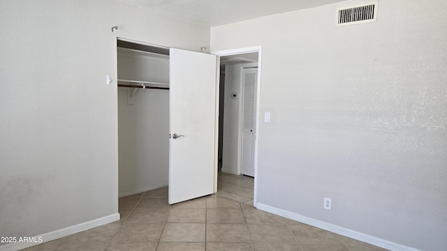10232 N 86th St, Scottsdale, AZ 85258 - unfurnished bedroom featuring tile patterned flooring and a closet