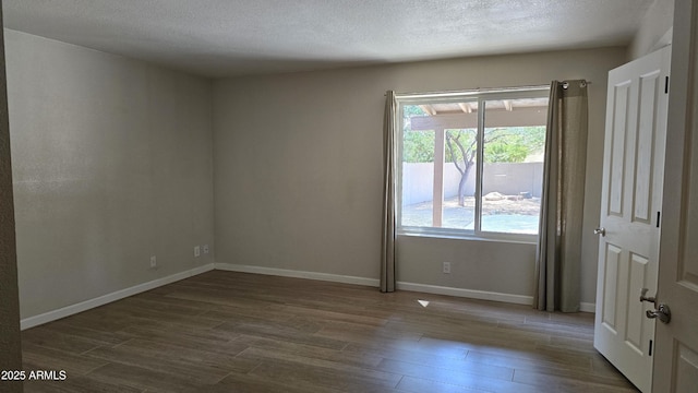 10232 N 86th St, Scottsdale, AZ 85258 - spare room featuring dark wood-style flooring and a textured ceiling