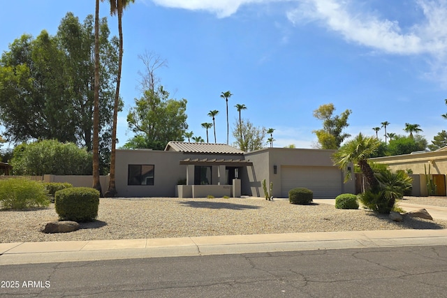 10232 N 86th St, Scottsdale, AZ 85258 - pueblo-style home featuring stucco siding, a garage, and driveway