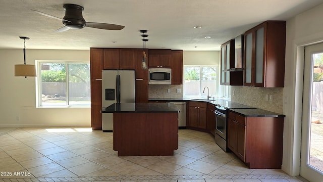 10232 N 86th St, Scottsdale, AZ 85258 - kitchen with stainless steel appliances, dark countertops, a kitchen island, and healthy amount of natural light