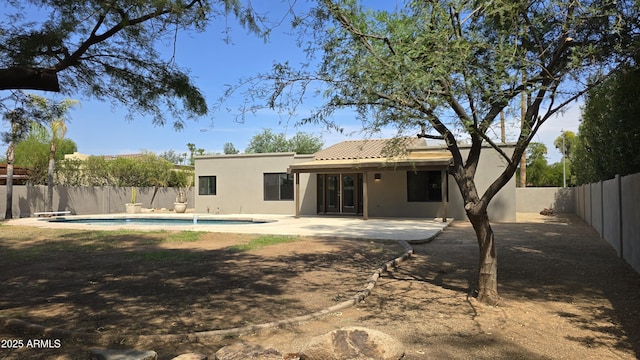 10232 N 86th St, Scottsdale, AZ 85258 - rear view of house with a fenced backyard, stucco siding, a patio, and a tiled roof