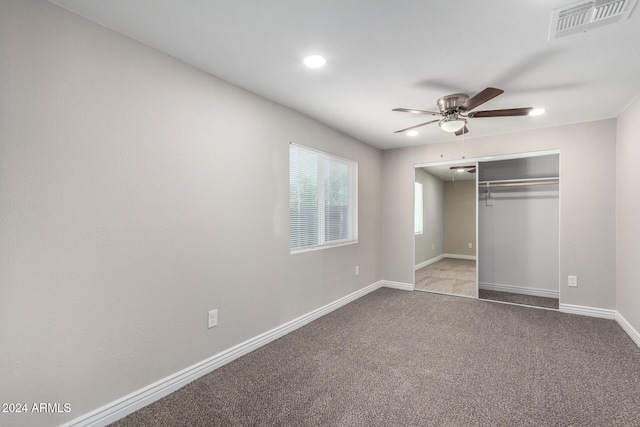 unfurnished bedroom featuring a closet, ceiling fan, and light colored carpet