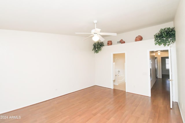 unfurnished room with ceiling fan and hardwood / wood-style flooring