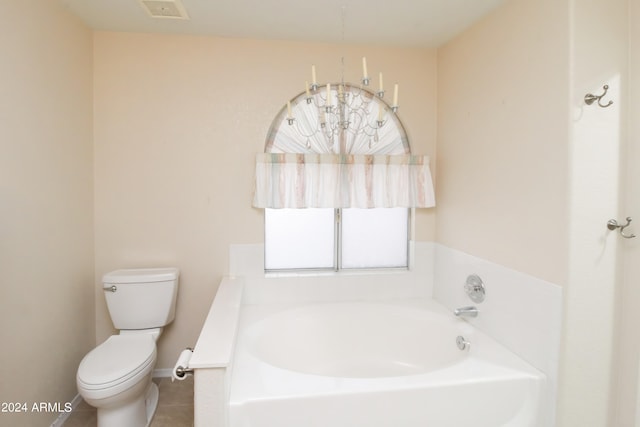 bathroom featuring a tub to relax in, toilet, and tile patterned flooring