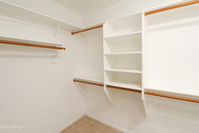 spacious closet featuring light tile patterned floors