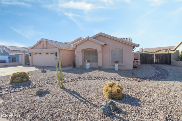 view of front of home with solar panels and a garage