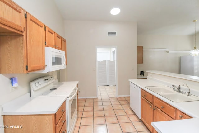 kitchen with white appliances, sink, hanging light fixtures, and light tile patterned floors