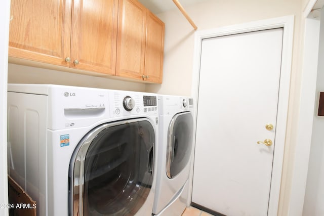 laundry area featuring cabinets and washing machine and clothes dryer