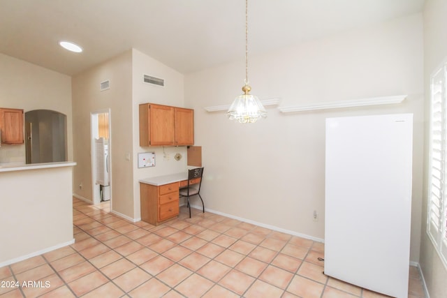 kitchen featuring light tile patterned floors, high vaulted ceiling, a wealth of natural light, and pendant lighting