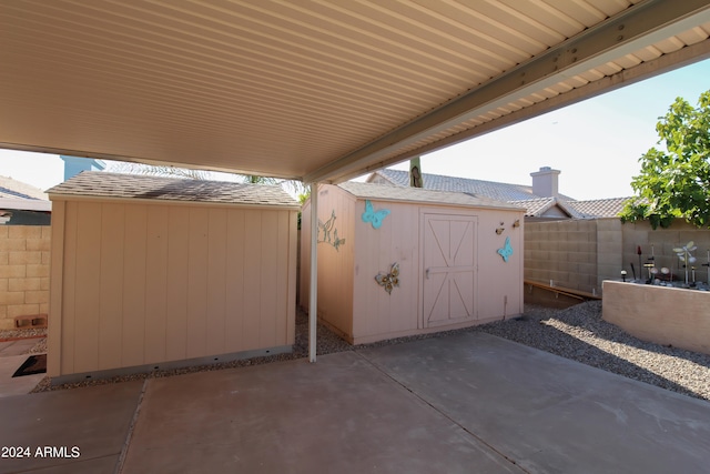 view of patio featuring a shed