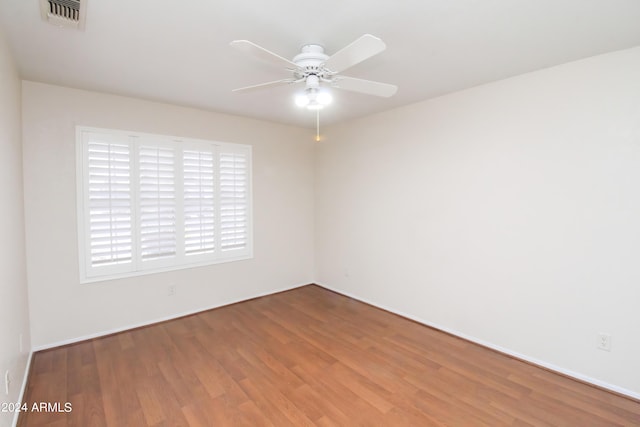 empty room with ceiling fan and wood-type flooring