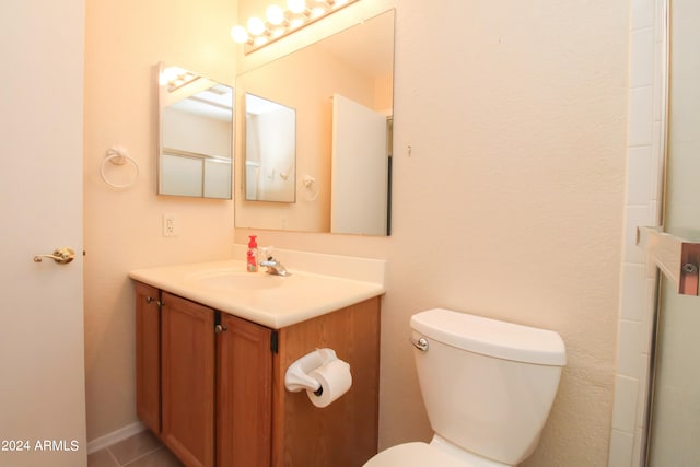 bathroom featuring vanity, tile patterned flooring, and toilet