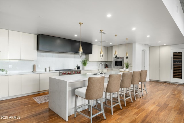 kitchen featuring sink, oven, white cabinets, and tasteful backsplash