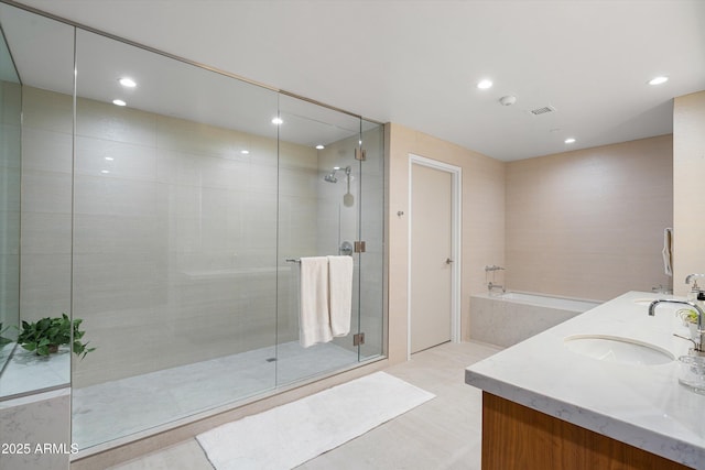 bathroom with shower with separate bathtub and vanity