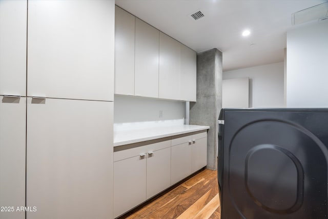 kitchen with white cabinets and light wood-type flooring