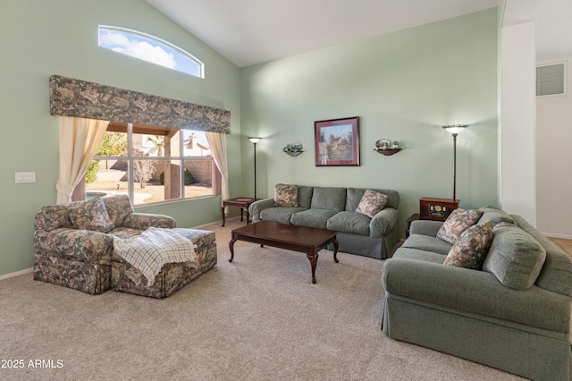 living room with high vaulted ceiling and carpet