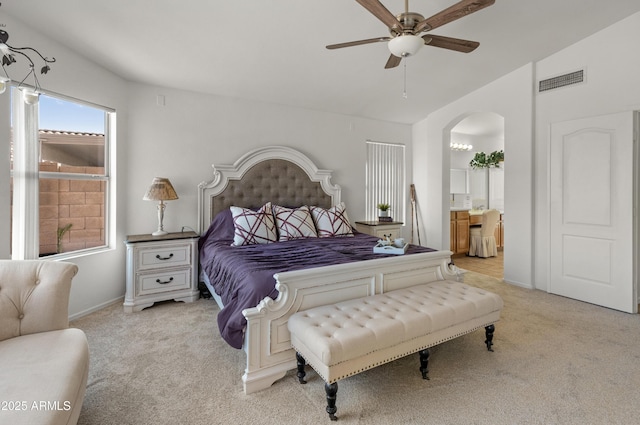 carpeted bedroom with connected bathroom and ceiling fan