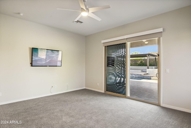 carpeted spare room featuring ceiling fan