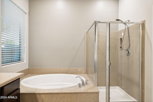 bathroom featuring vanity and separate shower and tub